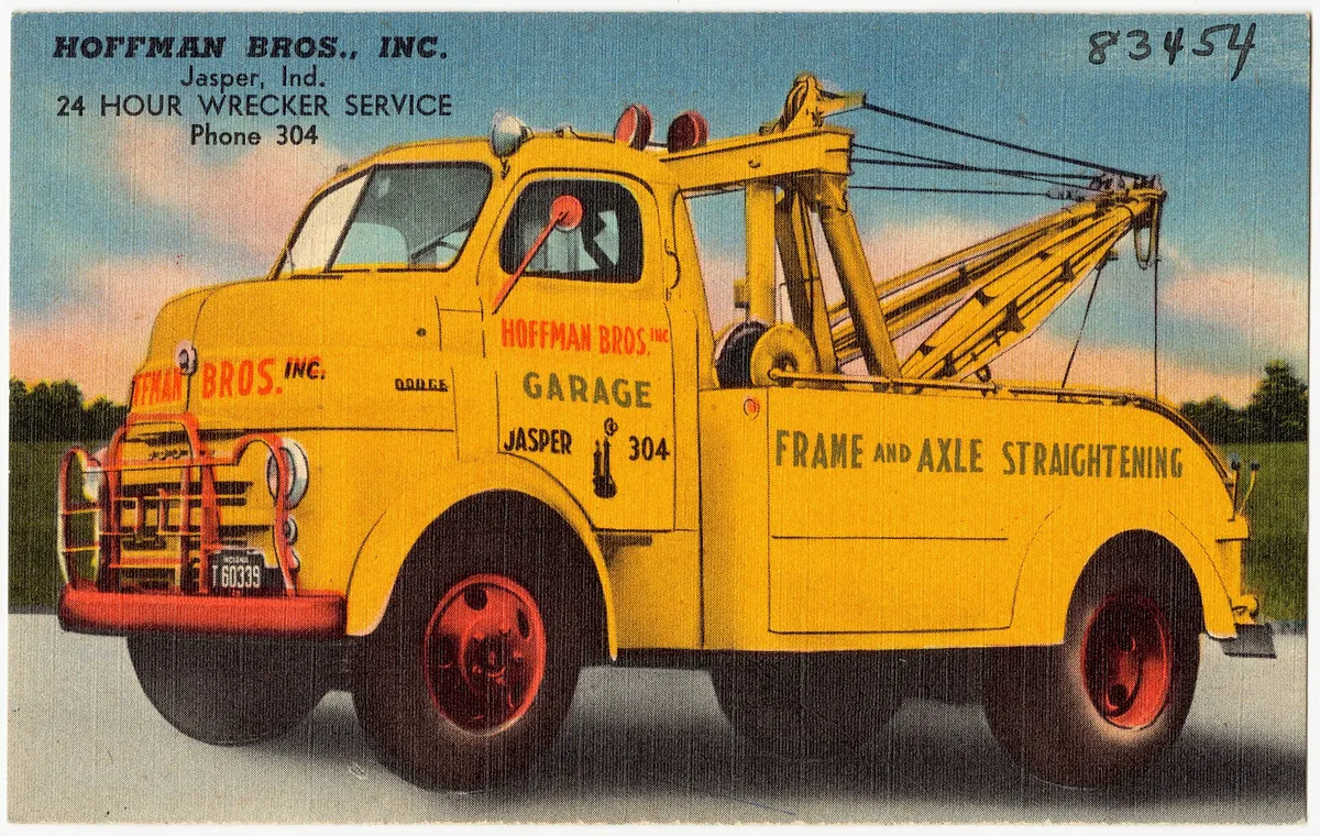 A yellow wrecker on an old postcard